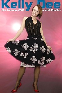 Kelly Dee Sensually Poses In Her Night Dress On The Red Background