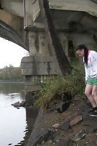 Brunette Bitch Pisses Next To A Flowing River