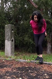 Black Haired Lass Squats To Piss On A Road