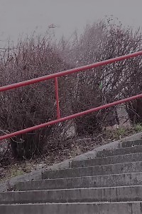 Black Haired Babe Pisses Down Concrete Steps