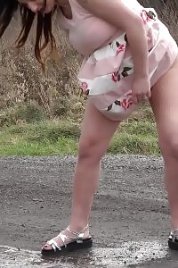 Preggo Brunette Pisses On The Ground Outdoors
