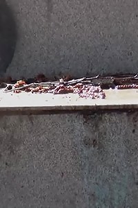 Black-haired Doll Pisses Down Some Concrete Steps