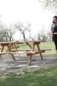 Eveline Neill Squats And Taking A Leek On Picnic Bench