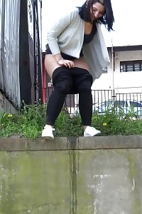 Black Haired Gal Sprinkles Her Pee Off A Ledge