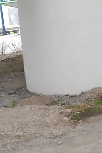 Petrol Station Peeing Behind A Big Pillar
